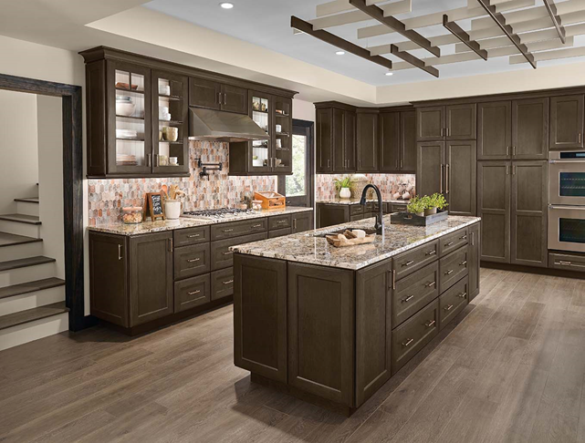 Kitchen with grey cabinetry and colorful backsplash